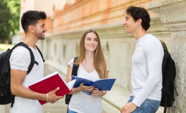 three-students-talking-to-each-other-outdoor-in-a-college-courtyard_53419-7532